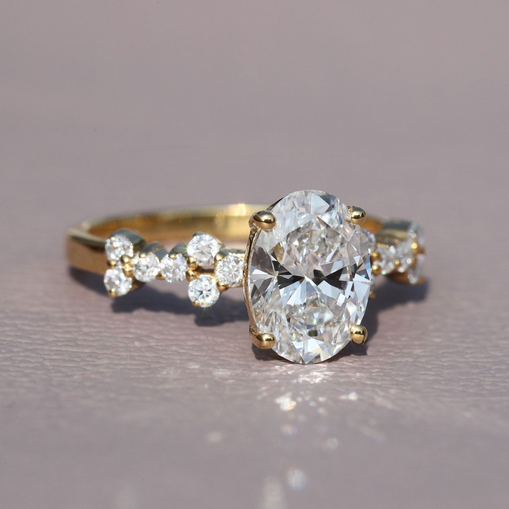 Stylishly crafted this unique oval and round cut solitaire diamond ring in 14 kt yellow gold lab grown diamonds